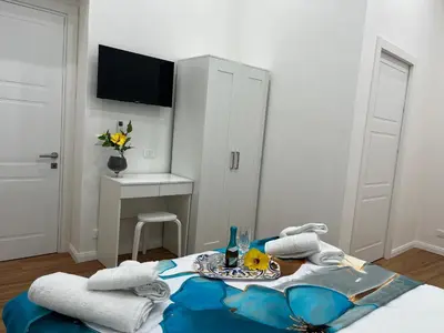 a room with a bed with a table with towels at Aurora Center City - Rooms in Palermo