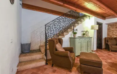 a living room with stairs and a chair at 3 Bedroom Amazing Home In Partinico in Partinico