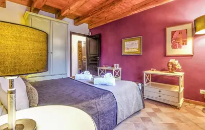 a bedroom with a bed and a purple wall at 3 Bedroom Amazing Home In Partinico in Partinico