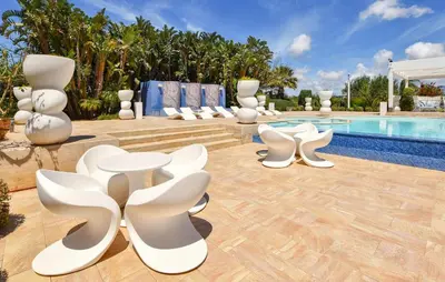 a group of white chairs sitting next to a swimming pool at 3 Bedroom Amazing Home In Partinico in Partinico