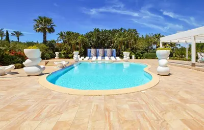 a swimming pool in a patio with chairs and a table at 3 Bedroom Amazing Home In Partinico in Partinico