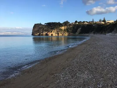 a beach with a rocky shoreline and the ocean at Casa Marina con vista sul castello in Castellammare del Golfo
