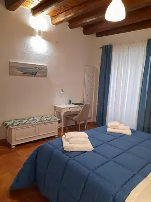 a bedroom with two blue beds and a table at Casa Kyla in Palermo