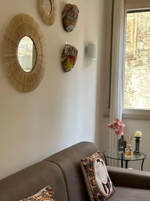 a living room with a couch and a mirror and a table at coppola home in Palermo