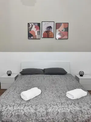a bedroom with a bed with four pictures on the wall at FM Home Stadio Renzo Barbera in Palermo