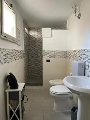 a bathroom with a toilet and a sink and a shower at FM Home Stadio Renzo Barbera in Palermo