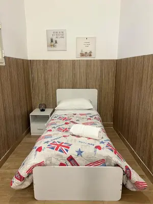 a bed in a room with at FM Home Stadio Renzo Barbera in Palermo