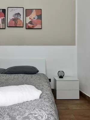 a bedroom with a bed and three pictures on the wall at FM Home Stadio Renzo Barbera in Palermo