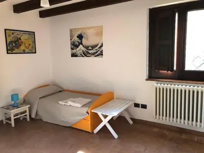 a small bedroom with a bed and a bench at Villa Rubino ai Colli in Palermo