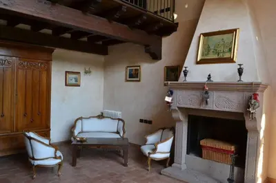 a living room with two chairs and a fireplace at Villa Rubino ai Colli in Palermo