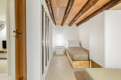 a bedroom with a bed and a wooden ceiling at GuestHost - Central Station Modern Apartment with Balconies x8 in Palermo