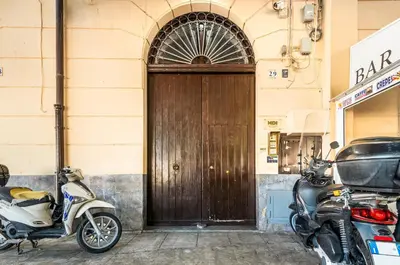 a pair of motorcycles parked in front of a wooden door at GuestHost - Central Station Modern Apartment with Balconies x8 in Palermo