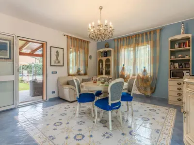 a dining room with a table and chairs at Villa Olivella by Interhome in Cefalù