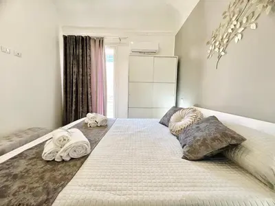 a bedroom with a large bed with towels on it at Soevi Appartamenti in Carini