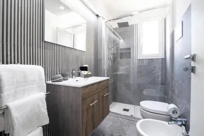 a bathroom with a shower and a sink and a toilet at Soevi Appartamenti in Carini