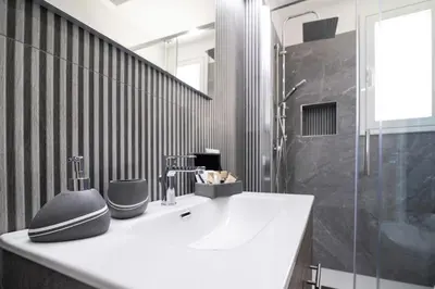 a bathroom with a sink and a shower at Soevi Appartamenti in Carini
