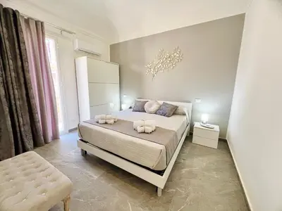 a bedroom with a bed with two towels on it at Soevi Appartamenti in Carini