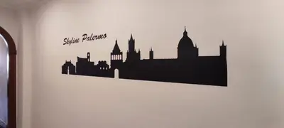 a black silhouette of a city on a wall at Skyline Palermo in Palermo