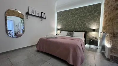 a bedroom with a bed and a large mirror at LA SPLENDIDA Dimora di Charme - Luxury Loft Palermo in Palermo