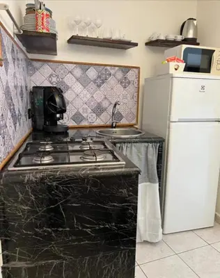 a kitchen with a stove and a refrigerator at Sicily guest house 2 in Palermo