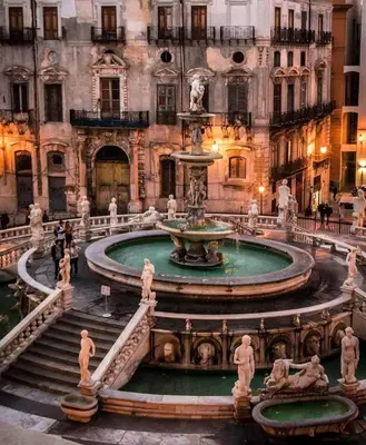a fountain in the middle of a building at Panormus Guest Apartment in Palermo