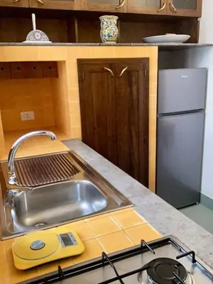 a kitchen counter with a sink and a stove at Villa Orlando Mondello in Palermo