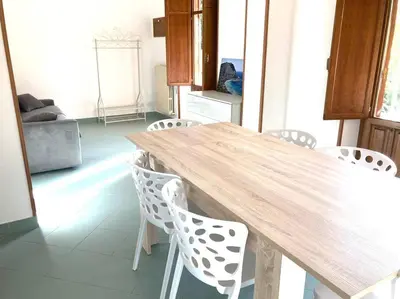 a wooden table and chairs in a room at Villa Orlando Mondello in Palermo
