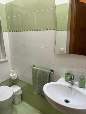 a bathroom with a sink and a toilet and a mirror at Casa Sciàlari in Palermo