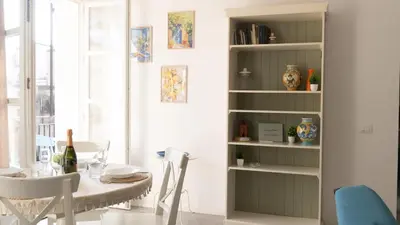 a dining room with a table and a book shelf at Aerial House in Palermo