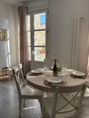 a dining room table with a bottle of wine on it at Aerial House in Palermo