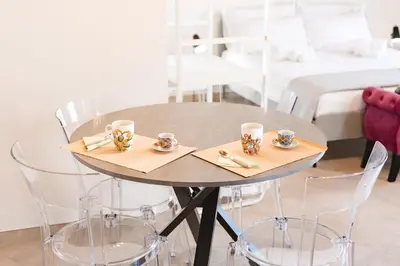 a table with chairs and cups on top of it at Masalia Loft in Palermo