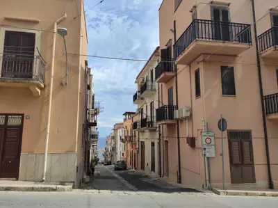 an alley with buildings on a city street at Guzzari 75 Home in Castellammare del Golfo