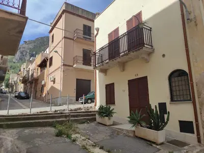 a building with two balconies on a street at Guzzari 75 Home in Castellammare del Golfo
