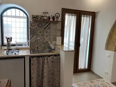 a kitchen with a sink and a window at Guzzari 75 Home in Castellammare del Golfo