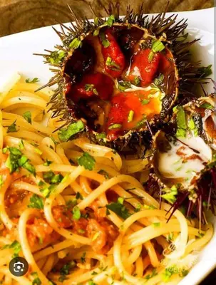 a plate of pasta with meat and sauce on it at Makari Sweet Sunsets in Macari