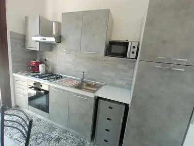 a small kitchen with a sink and a microwave at Makari Sweet Sunsets in Macari