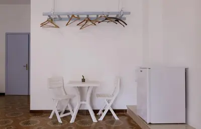 a dining room with a table and two chairs at Umàri Rooms in Castellammare del Golfo
