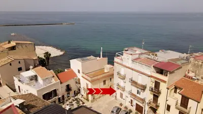 an aerial view of buildings and the ocean at Umàri Rooms in Castellammare del Golfo