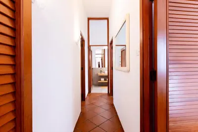 a hallway with several doors and a tile floor at Vista Mare by DomuSicily in Cinisi