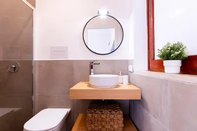 a bathroom with a sink and a mirror at Vista Mare by DomuSicily in Cinisi