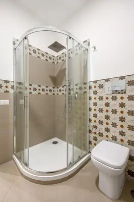 a shower stall in a bathroom with a toilet at Maison169 in Palermo