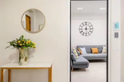 a living room with a couch and a mirror at Maison169 in Palermo