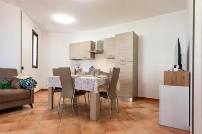 a kitchen and dining room with a table and chairs at Villa Diamante in Campofelice di Roccella