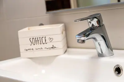 a bathroom sink with a soap box sitting on top of it at Villa Diamante in Campofelice di Roccella