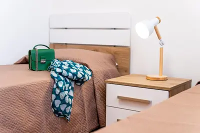 a bedroom with a bed and a lamp on a night stand at Villa Diamante in Campofelice di Roccella