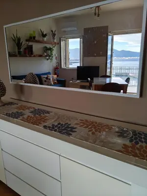 a living room with a large mirror over a counter at Il Balcone sul mare - free parking & relax in Palermo
