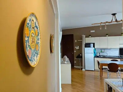 a plate hanging on a wall in a kitchen at Il Balcone sul mare - free parking & relax in Palermo