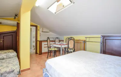 a bedroom with a bed and a table and chairs at Awesome Apartment In Trabia in Trabia
