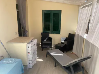 a room with chairs and a table and a window at Appartamento Florio in Palermo