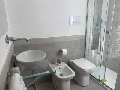 a bathroom with a sink and a toilet and a shower at Appartamento Florio in Palermo